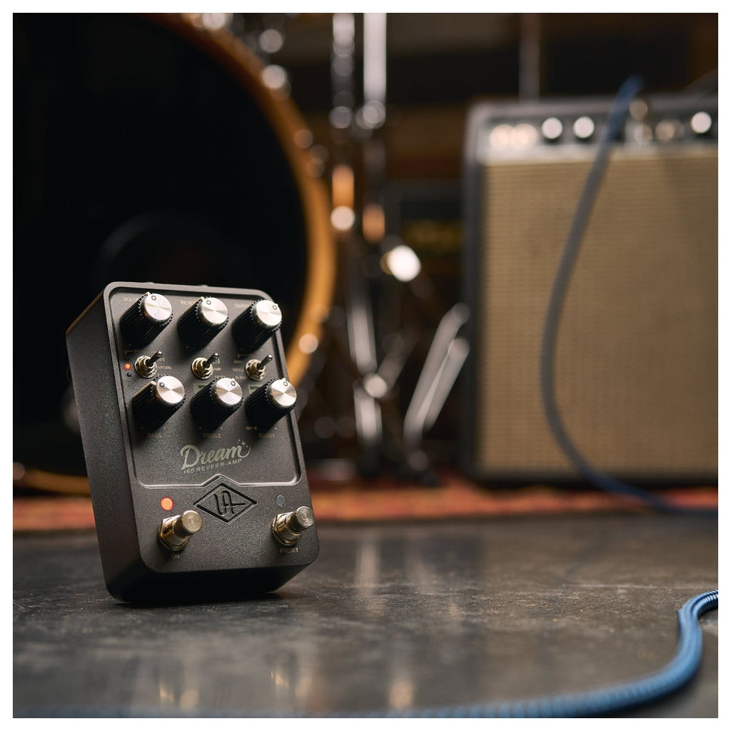 Universal Audio Dream '65 Reverb Amplifier pedal in a studio setting, showcasing its sleek design and control knobs.