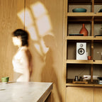 Bowers & Wilkins 607 S3 passive bookshelf speakers in white, shown in a lifestyle setting with a modern home interior.
