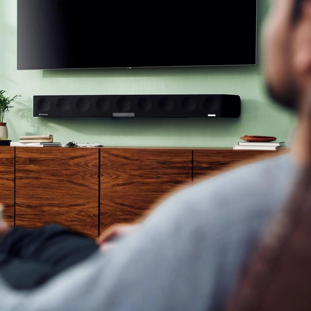 Sennheiser Ambeo Soundbar Max with sleek black design, multiple speaker drivers, and control buttons on the top for immersive TV sound.