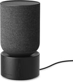 Bang & Olufsen Beosound Balance wireless speaker with sleek cylindrical design and premium wooden finish.
