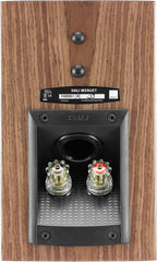 DALI Menuet passive bookshelf speakers shown in a natural setting with wood finish and compact design for home audio systems.