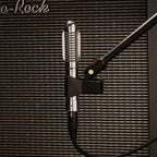 Warm Audio Fen-tone ribbon microphone shown in a natural studio setting, highlighting its vintage design and sturdy build.