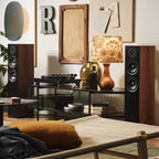 Argon Audio Forus 55 passive floorstanding speakers with black finish, showing sleek design and speaker drivers in a home audio setup.