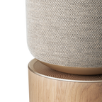 Bang & Olufsen Beosound Balance wireless speaker with natural wood finish and sleek modern design, detailed close-up image.