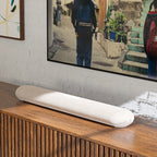 Bluesound Pulse Cinema Mini soundbar with sleek design, positioned in a modern living room setup for high-quality TV audio.