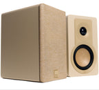 DALI Kupid passive bookshelf speakers in caramel white, showcasing sleek design and compact size for high-quality audio.