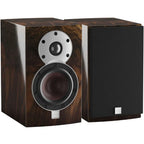 DALI Menuet SE passive bookshelf speakers with black front grille and wooden side panels, compact and stylish home audio speakers