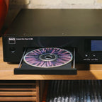 NAD C 589 CD player with open drawer, front view showing disc tray and sleek black design.