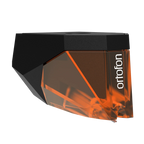 Ortofon 2M Bronze turntable cartridge with stylus, angled to the right, showcasing high-quality audio equipment.