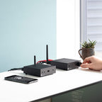 Pro-Ject Stream Box S2 music streamer in black, shown connected to audio equipment in a modern home entertainment setup.