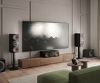 DALI Rubikore Cinema center speaker placed in a modern living room setting, showcasing sleek design and compact size.
