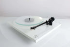 Rega Planar 2 turntable with Nd3 cartridge, showcasing its sleek design and tonearm on a wooden surface.
