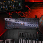Sequential Take 5 Desktop synthesizer shown with controls and keyboard interface on a sleek black unit.