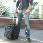 UDG SlingBag Trolley Deluxe MK2 in black, showcasing a stylish design with wheels and ample storage for DJ equipment.
