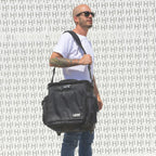 UDG SlingBag Trolley Deluxe MK2 in black, featuring wheels and a spacious design for DJ equipment and essentials.