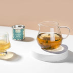 Dvaro Kavos Whole Leaf Spearmint Tea 10g in a clear package with fresh green spearmint leaves and tea leaves visible.