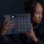 AlphaTheta SLAB MIDI controller with a sleek black top surface and multiple control knobs and pads for music production.