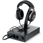 Focal Elear high-fidelity over-ear headphones with sleek design, shown with an Arche amplifier and DAC for premium sound quality.