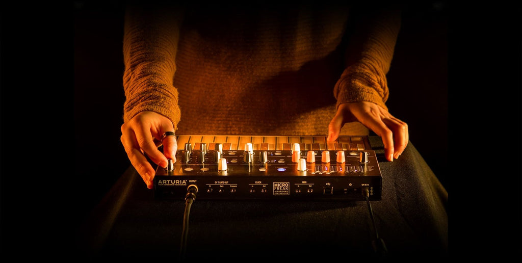 Arturia Microfreak synthesizer, lifestyle being played by hand