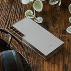 Astell&Kern PD10 portable music player in a lifestyle setting, showing its sleek design and compact size for high-quality audio.