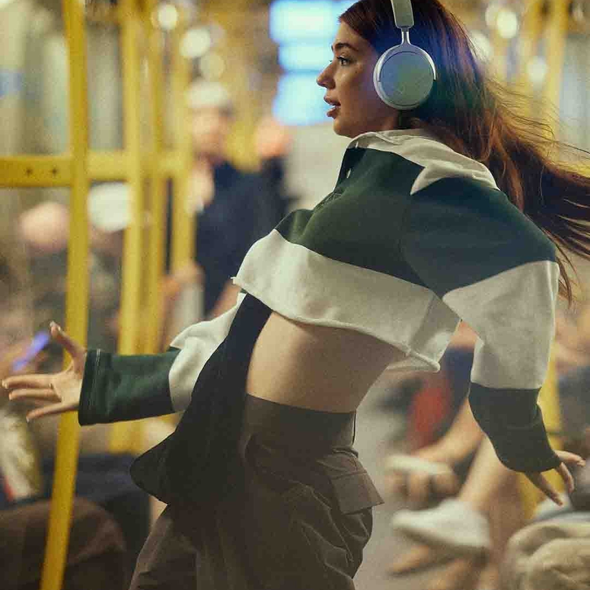 Beyerdynamic Aventho Y in Soft Jade worn on a tram