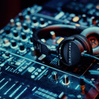 Beyerdynamic DT 275 PRO headphones resting on a DJ mixer