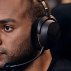 Gamer wearing the Beyerdynamic MMX 100 Wireless headset in black at a gaming setup