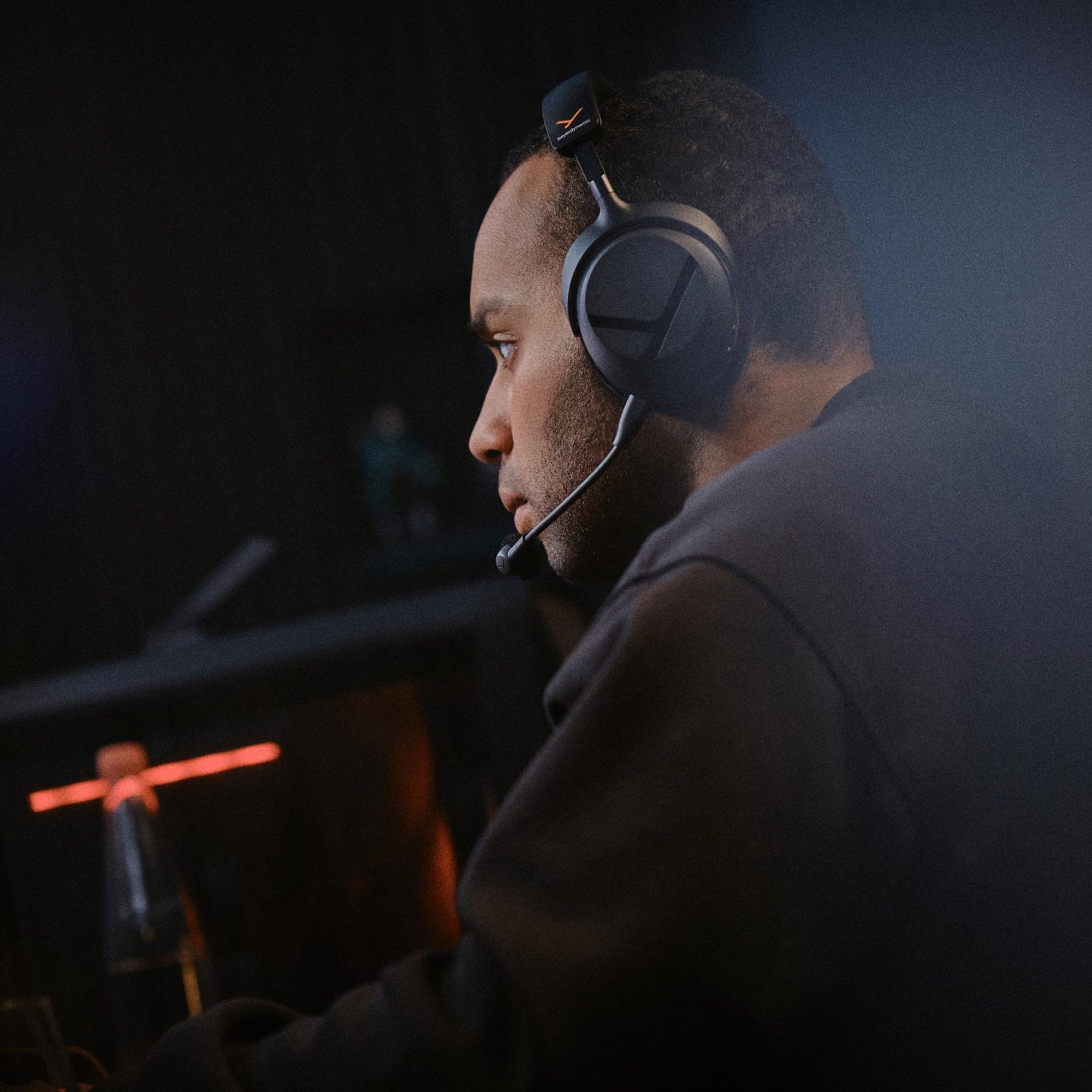Player using the Beyerdynamic MMX 100 Wireless headset in a dark gaming room