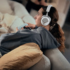 Woman relaxing on a couch while wearing the Beyerdynamic MMX 130 Wireless headset