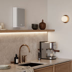 DALI Sonik On-Wall in-wall and outdoor speaker with sleek design, mounted on a wall, showcasing modern audio equipment.
