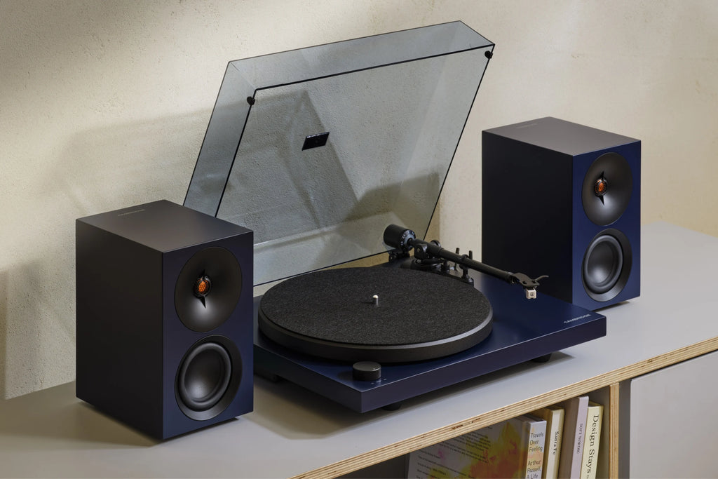 Cambridge Audio Spira turntable in Blue on a shelf with matching L/R speakers