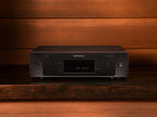 Marantz CD 60 black CD player with sleek design, showing top view and front display on a studio surface.
