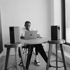 AIAIAI UNIT-4 Wireless+ active nearfield monitors shown with sleek black finish and front speaker grille on a studio desk.