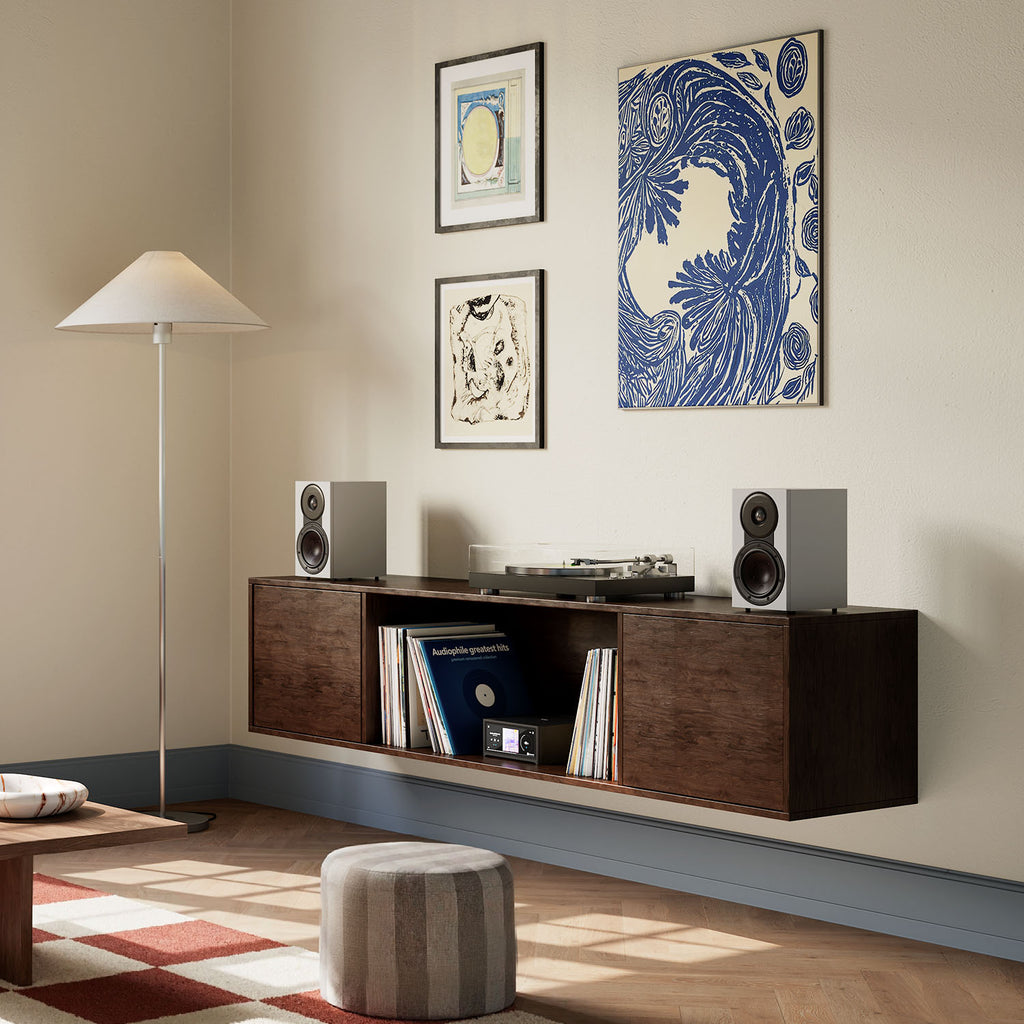 DALI Sonik 1 passive bookshelf speakers with black cabinets and sleek design, showcased on a white background.