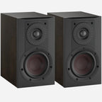 Pair of DALI Opticon 1 MK2 passive bookshelf speakers in tobacco oak finish, showcasing their sleek design and wood grain texture.
