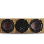 DALI Rubikore Cinema center speaker in natural walnut finish, showcasing the sleek design and wood grain details.