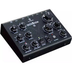 Erica Synths Acidbox III effects pedal with colorful knobs and input/output jacks, used for acid basslines and synth sounds.