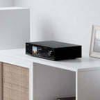 Eversolo DMP-A8 Gen 2 on a white shelf beside a loudspeaker