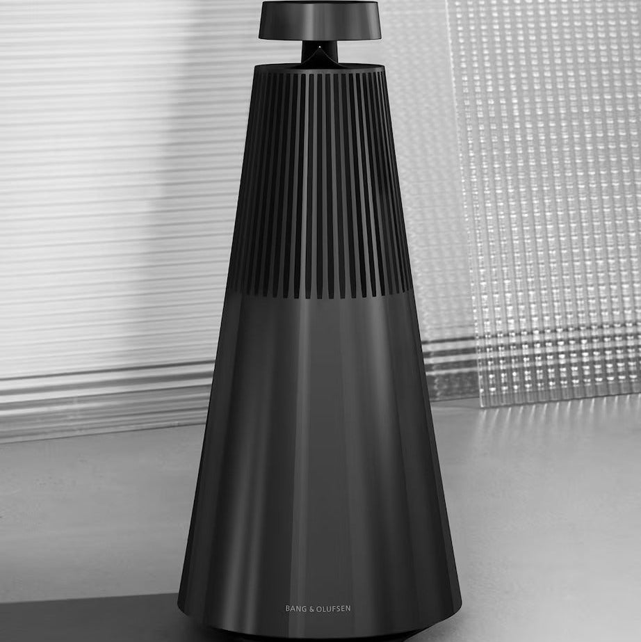 Bang & Olufsen Beosound 2 3rd Gen wireless speaker, sleek cylindrical design with fabric cover and control buttons visible.