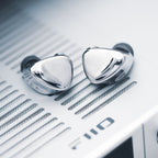 FiiO FX17 in-ear headphones with black silicone tips and sleek design, shown from the side with cable and earbud visible.