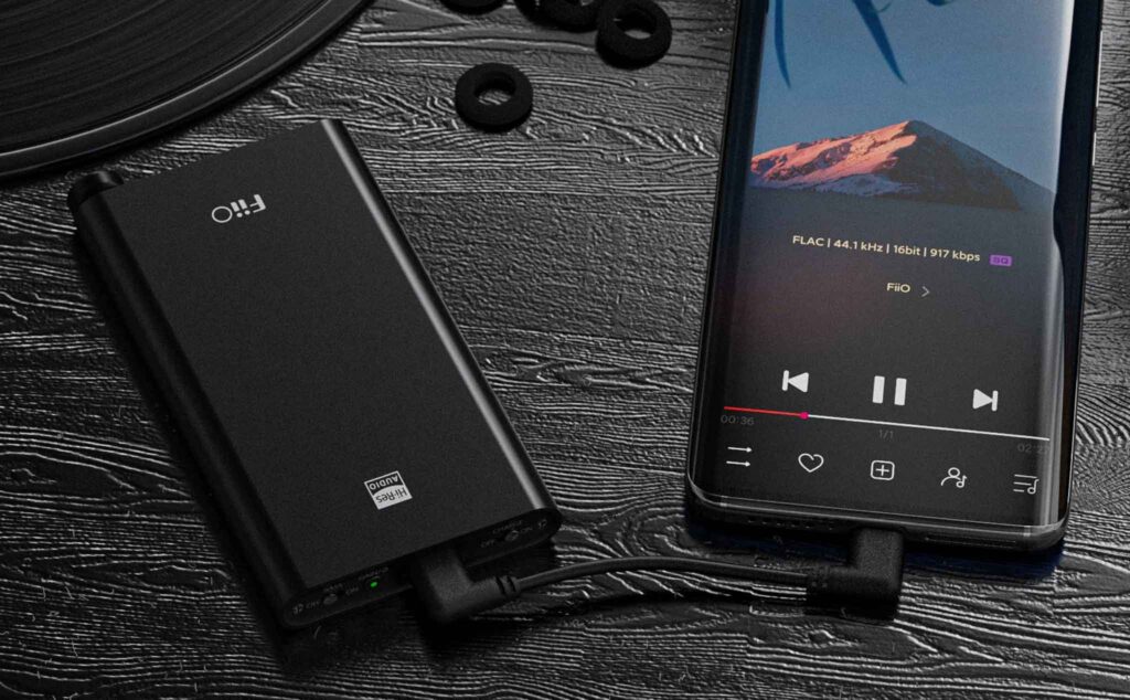 FiiO Q3 headphone amplifier and DAC with sleek design and multiple input options, showcasing connections and controls.