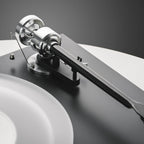 Pro-Ject Debut Reference 10 manual turntable with sleek design, featuring a tonearm and platter for high-quality vinyl playback.