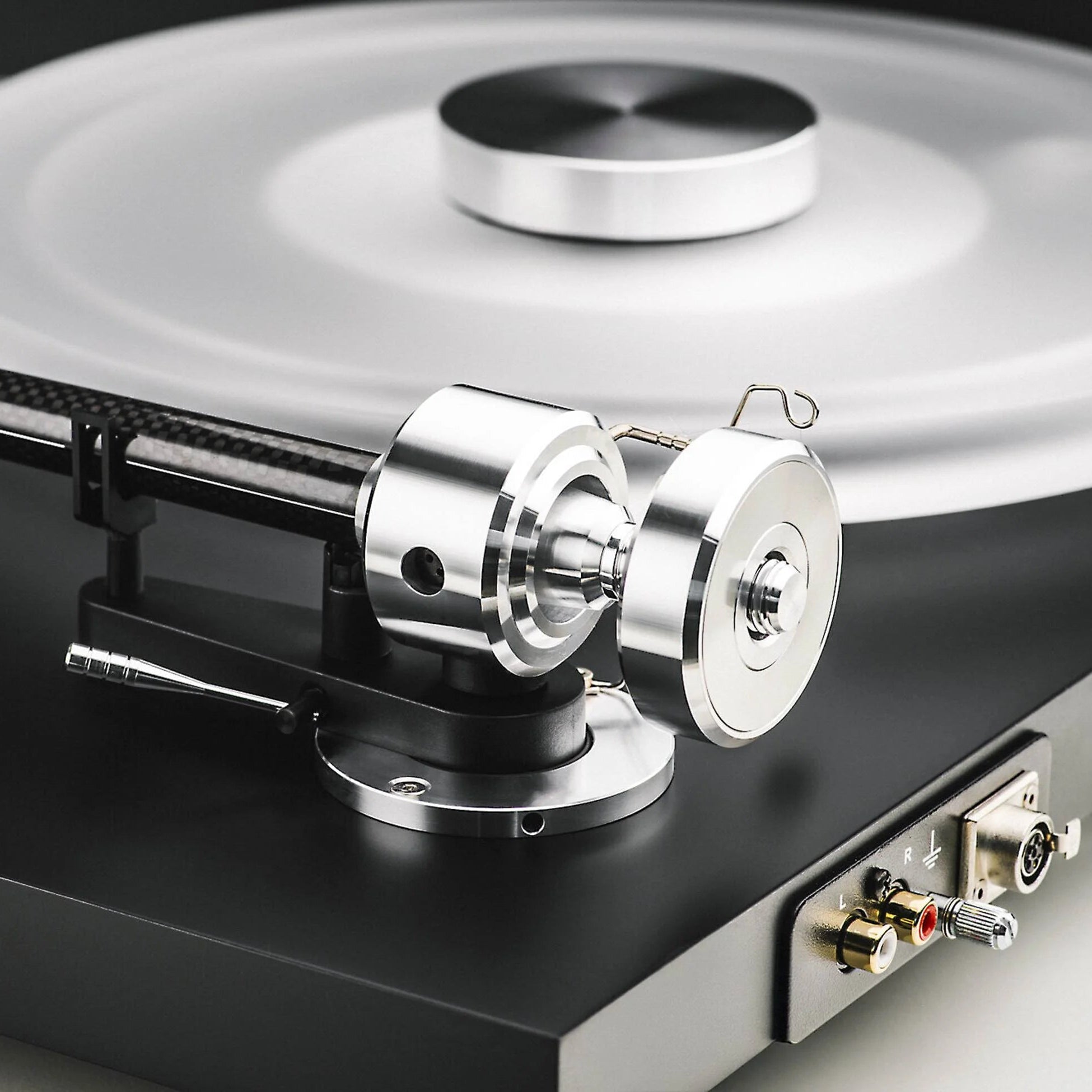 Pro-Ject Debut Reference 10 manual turntable with a sleek black finish and tonearm, showcasing high-quality audio equipment.