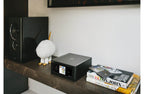 NAD M10 V3 stereo amplifier with sleek design and control knobs, showcasing its modern audio equipment features.