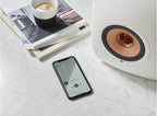 KEF LS50 Wireless II wireless speakers with sleek black finish and modern design, front view showing speaker grille and controls