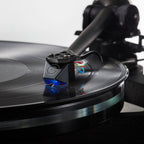 Goldring E4 turntable cartridge with gold-colored body and stylus, angled view showing detailed design and branding.
