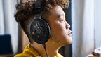 Sennheiser HD 660S2 open-back headphones with over-ear design and premium ear cups, displayed on a stand.