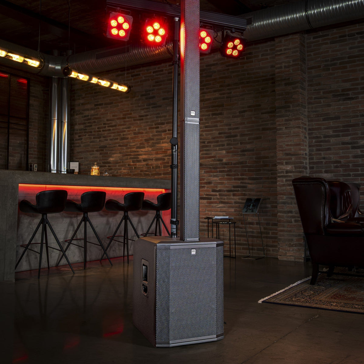 HK Audio POLAR 15 MK2 column PA system set up in a bar with stage lighting