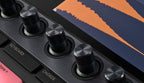 Native Instruments Maschine+ drum machine and sampler with colorful pads and interface, ready for music production.