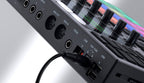 Native Instruments Maschine+ drum machine and sampler with touch-sensitive pads, display screen, and control knobs.